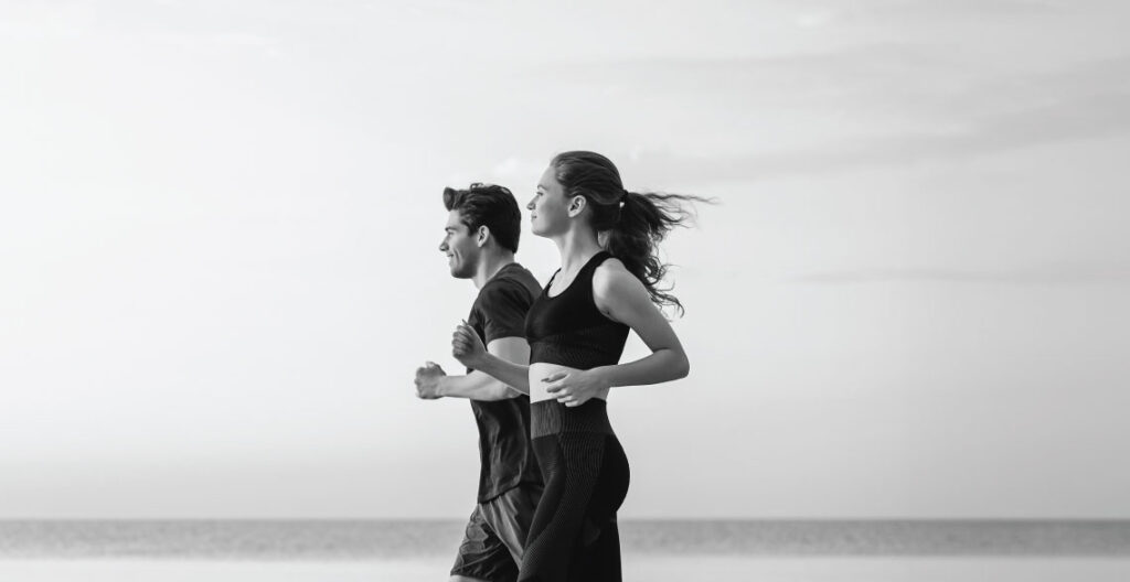 image of people running on the beach